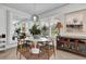 Charming breakfast nook with a round table, chairs, a large mirror, and natural light from the window at 10640 Tibbett St, Orlando, FL 32832