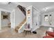 Bright foyer with light tile floors, staircase, decorative accents, and access to multiple rooms at 10640 Tibbett St, Orlando, FL 32832