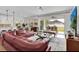 Inviting living room featuring a comfortable leather sofa, sliding glass doors to the patio, and a view of the kitchen at 10640 Tibbett St, Orlando, FL 32832