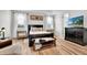 Elegant primary bedroom with modern furniture, hardwood floors, and bright natural light at 10640 Tibbett St, Orlando, FL 32832