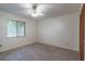 Cozy bedroom with neutral carpet, a window, and closet with paneled doors at 109 Poinciana Ln, Deltona, FL 32738