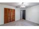 Bedroom featuring neutral carpet, paneled closet doors, and a ceiling fan at 109 Poinciana Ln, Deltona, FL 32738