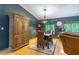 Dining area featuring a wooden table with woven chairs, a decorative cabinet, and stylish lighting at 109 Poinciana Ln, Deltona, FL 32738
