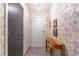 Bright entryway with decorative wallpaper, tiled floor, and a wooden console table at 109 Poinciana Ln, Deltona, FL 32738