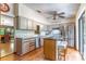 Bright kitchen featuring stainless steel appliances, island with seating, and backyard access at 109 Poinciana Ln, Deltona, FL 32738