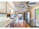 Updated kitchen with white cabinets, stainless steel appliances, and breakfast bar at 109 Poinciana Ln, Deltona, FL 32738