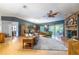 Spacious living room with hardwood floors, brick fireplace, and a sliding glass door to the backyard at 109 Poinciana Ln, Deltona, FL 32738