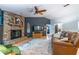 Cozy living room with a brick fireplace, plush seating, and an open layout, ideal for relaxing at 109 Poinciana Ln, Deltona, FL 32738