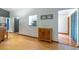 Inviting living room featuring hardwood floors, stylish cabinet, and bright, open layout at 109 Poinciana Ln, Deltona, FL 32738
