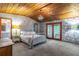 Cozy bedroom featuring wood ceiling, elegant wallpaper, and an abundance of natural light at 109 Poinciana Ln, Deltona, FL 32738