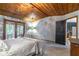 Comfortable bedroom showcasing a unique wood ceiling, chandelier, and access to a sunroom at 109 Poinciana Ln, Deltona, FL 32738