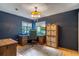 Stylish home office with hardwood floors, large windows, and ample storage space at 109 Poinciana Ln, Deltona, FL 32738