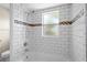 Tiled bathroom featuring shower, bathtub and mosaic accent tile at 110 Rabun Ct, Sanford, FL 32773
