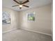 Empty bedroom with two windows, a ceiling fan, and neutral carpet at 110 Rabun Ct, Sanford, FL 32773