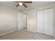 Carpeted bedroom with a ceiling fan, neutral colors and closet at 110 Rabun Ct, Sanford, FL 32773