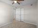 Cozy bedroom showcasing carpet, ceiling fan, closet, and access to a hall at 110 Rabun Ct, Sanford, FL 32773