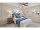 Bedroom with carpet, ceiling fan, queen bed, and two windows at 110 Rabun Ct, Sanford, FL 32773