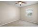 Neutral bedroom featuring plush carpet, ceiling fan, and a window with a view at 110 Rabun Ct, Sanford, FL 32773