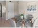 Cozy dining area featuring a glass table, modern decor, and access to the living room at 110 Rabun Ct, Sanford, FL 32773