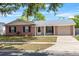 Well-maintained single-story home features brick accents, a manicured lawn, and an attached one car garage at 110 Rabun Ct, Sanford, FL 32773