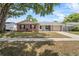 Charming single-story home with a brick facade, lush lawn, and mature shade tree in a quiet neighborhood at 110 Rabun Ct, Sanford, FL 32773