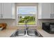 Kitchen sink with a double basin and a view of the backyard through the window at 110 Rabun Ct, Sanford, FL 32773