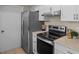 Functional kitchen space with stainless steel appliances, white cabinets, and durable countertops at 110 Rabun Ct, Sanford, FL 32773