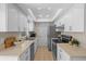 Efficient kitchen featuring white cabinets, modern appliances, and ample counter space for cooking at 110 Rabun Ct, Sanford, FL 32773
