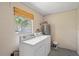 Laundry room with washer, dryer, hot water tank and window for natural light at 110 Rabun Ct, Sanford, FL 32773
