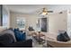 Relaxing living room featuring tile floors, modern decor, comfortable seating, and a ceiling fan at 110 Rabun Ct, Sanford, FL 32773