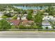 Neighborhood aerial showcasing the proximity to a serene lake surrounded by mature trees and beautiful houses at 119 Glendale Dr, Longwood, FL 32750