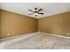 Empty bedroom featuring ceiling fan, light beige walls, and laminate flooring at 119 Glendale Dr, Longwood, FL 32750