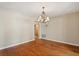 Empty dining room with chandelier, light beige walls, and wood-look flooring at 119 Glendale Dr, Longwood, FL 32750