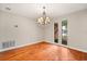 Dining room features hardwood floors, chandelier, and natural light from two windows at 119 Glendale Dr, Longwood, FL 32750