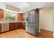 Modern kitchen featuring stainless steel refrigerator, wood cabinets, and a large window at 119 Glendale Dr, Longwood, FL 32750