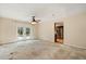 Living room with ceiling fan and French doors with view into the kitchen at 119 Glendale Dr, Longwood, FL 32750