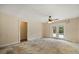 Bright living room features ceiling fan and French doors to backyard pool at 119 Glendale Dr, Longwood, FL 32750