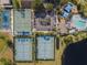 An aerial view of community tennis and basketball courts, swimming pool, parking area, and clubhouse at 1252 Ballyshannon Pkwy, Orlando, FL 32828