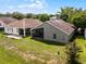 Backyard view with screen enclosed lanai offering additional outdoor living space on a sunny day at 1252 Ballyshannon Pkwy, Orlando, FL 32828