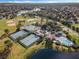 Aerial view featuring community tennis courts, baseball fields, swimming pool, and beautiful surrounding landscape at 1252 Ballyshannon Pkwy, Orlando, FL 32828