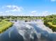 Scenic aerial view showcasing a beautiful lake in a neighborhood with clear sky and lush surroundings at 1252 Ballyshannon Pkwy, Orlando, FL 32828