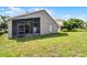 View of backyard with screen enclosed lanai offering additional outdoor living space on a sunny day at 1252 Ballyshannon Pkwy, Orlando, FL 32828