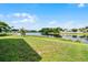 Large backyard with a green lawn and pond views, perfect for relaxation and recreation at 1252 Ballyshannon Pkwy, Orlando, FL 32828