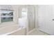 Bright bathroom with a separate tub and shower enclosure, and a large window at 1252 Ballyshannon Pkwy, Orlando, FL 32828