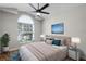 Comfortable bedroom with a large window and plush bedding and stylish decor at 1252 Ballyshannon Pkwy, Orlando, FL 32828