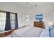 Bright bedroom featuring hardwood floors and a comfortable bed with blue accents at 1252 Ballyshannon Pkwy, Orlando, FL 32828