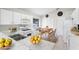 An open-concept kitchen featuring white cabinetry, modern appliances, and a cozy dining area with natural light at 1252 Ballyshannon Pkwy, Orlando, FL 32828