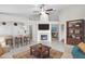 Bright living room with neutral walls, tile flooring, and a fireplace; features elegant furnishings and an open layout at 1252 Ballyshannon Pkwy, Orlando, FL 32828