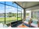 Screened porch with comfortable seating and views of the serene lake at 1252 Ballyshannon Pkwy, Orlando, FL 32828