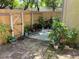 Backyard featuring brick pavers and a variety of potted plants, enclosed by a wooden fence at 1409 Oak Pl # F, Apopka, FL 32712